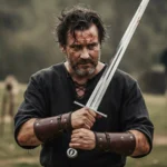 Swordsman holding a real bastard sword in battle
