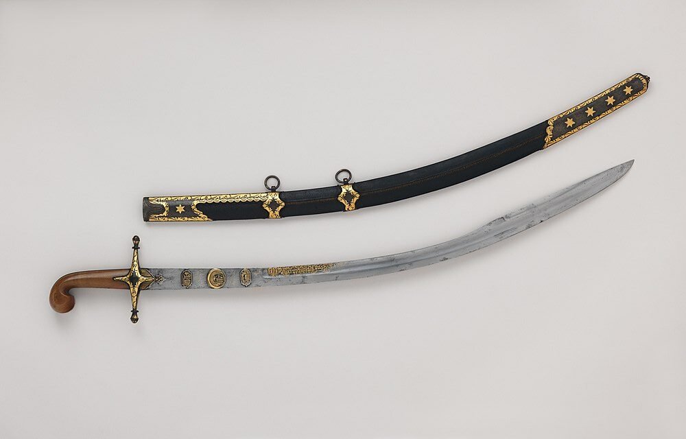 Turkish Kilij sword featuring a unique blade and a detailed black scabbard adorned with gold designs and stars, showcasing exquisite craftsmanship