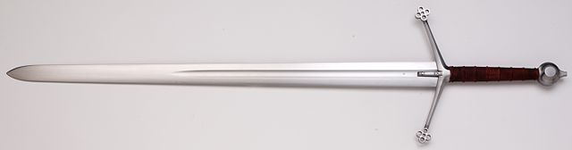 Scottish claymore sword with a quatrefoil cross-guard on a white background.