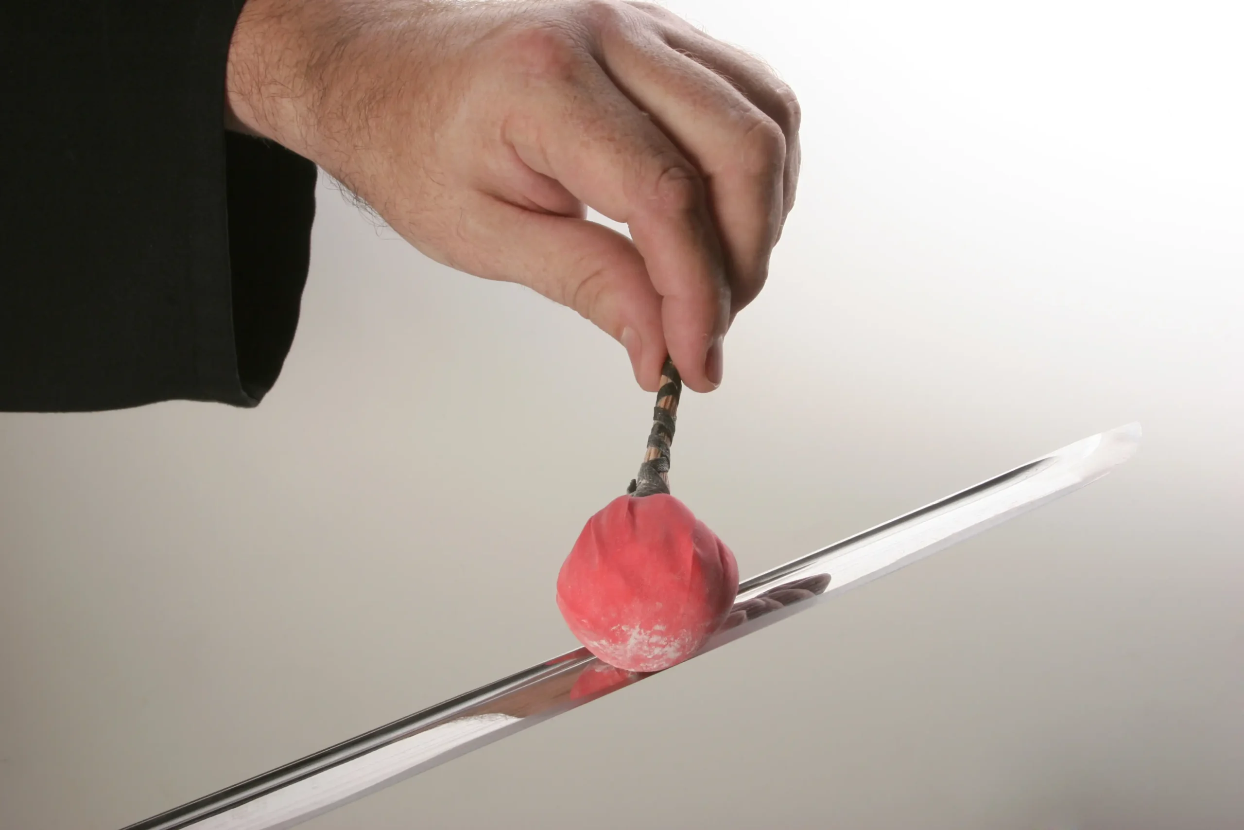 Applying uchiko powder to a katana blade using a traditional uchiko ball.