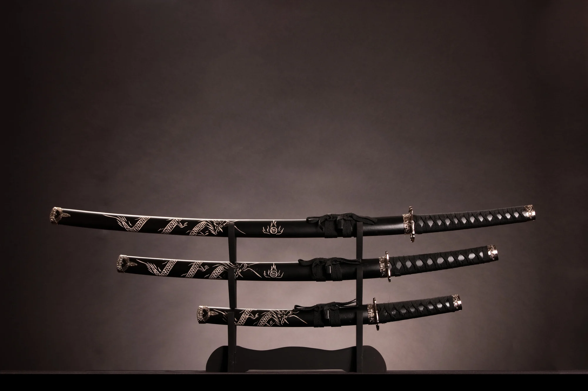 Samurai sword set displayed in a three layer stand.