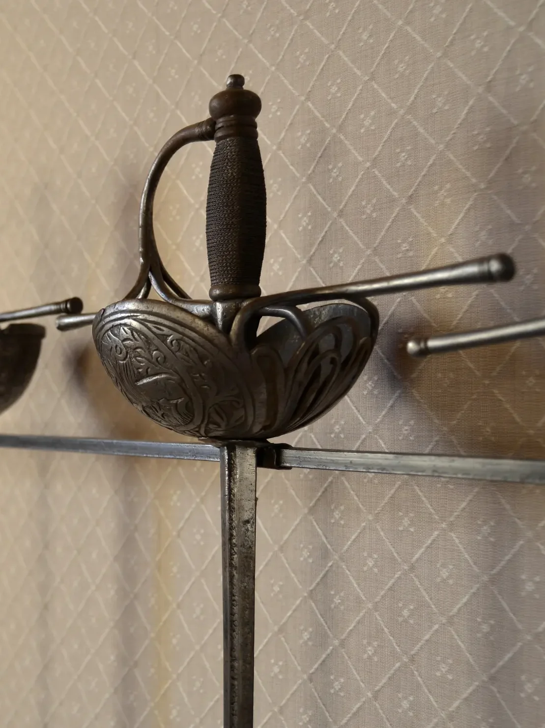 Cup-hilted Rapiers displayed in a wall.