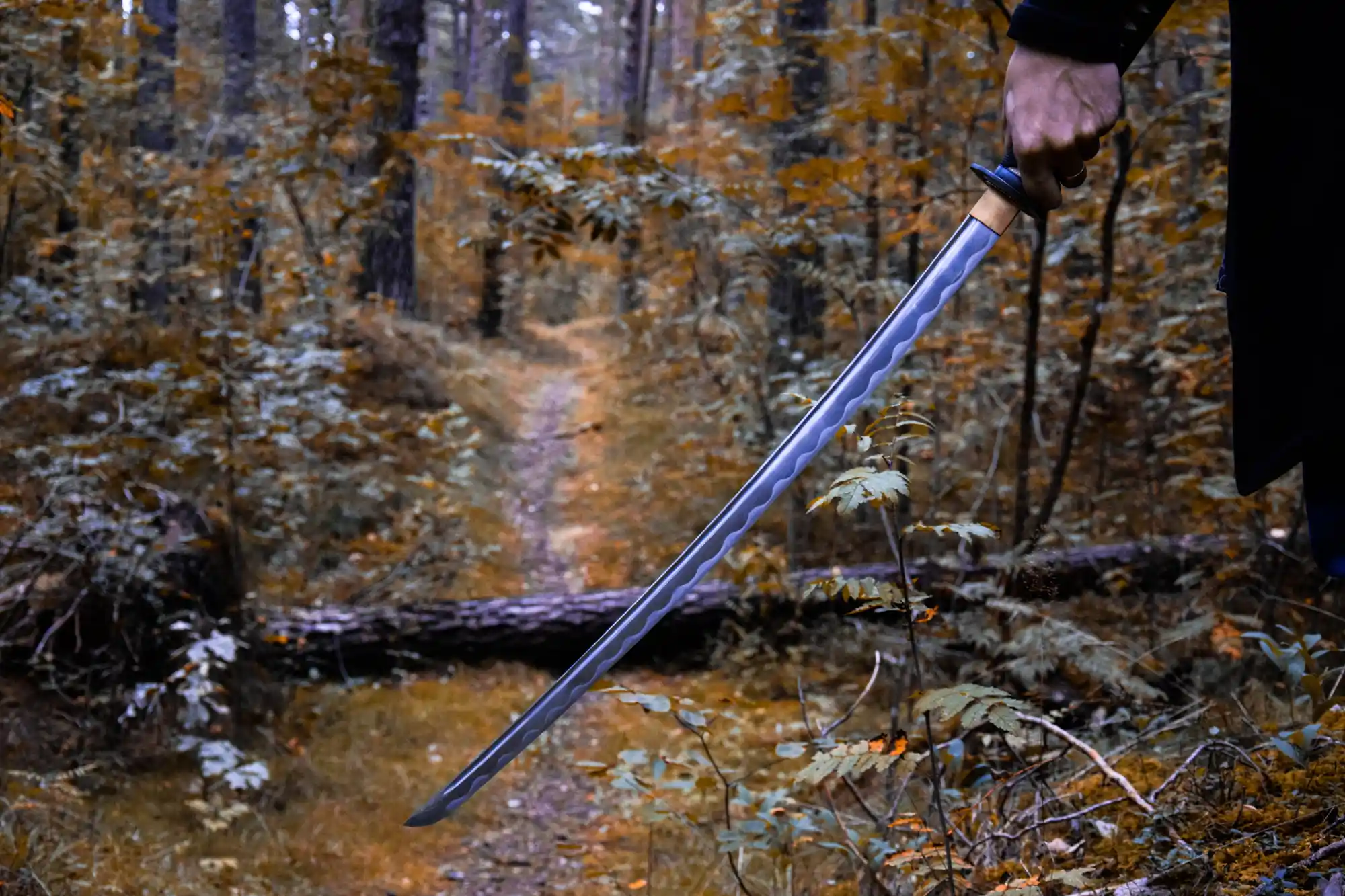 Katana sword held in a forest for self-defense.